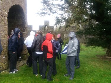 hooded students within the Trench mausoleum