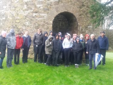Group standing outside the entrance to the family mausoleum