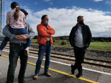 People standing on platform at station