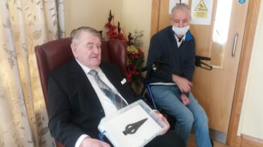 John Hynes holding the Moyarwood Spearhead, with Michéal Kilgannon looking on