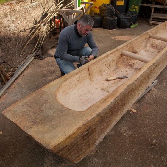 Mark Griffiths works on the replica Lee's Island Log boat | Photo Credit:  Brian MacDomhnaill