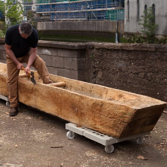 Mark Griffiths works on replica Lee's Island Log boat | Photo Credit:  Brian MacDomhnaill