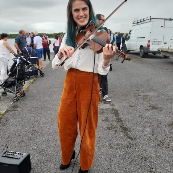 Musician Ciara Finan entertains the crowd at launch of Lee's Island 5 replica log boat at Knockferry pier | Moycullen Heritage