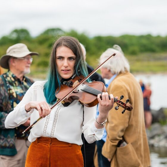 Musician Ciara Finan of Corofin at the launch of the replica Lee's Island 5 Log Boat | MyOptix