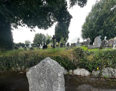 Limestone gravestone in Moycullen. While the front of the stone is carefully engraved, the back was left in its natural state revealing the brachipod at the back.