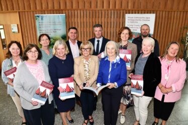Group standing with new publication
