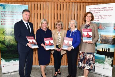Five people standing holding the new publication