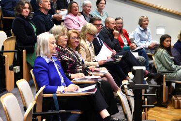 People sitting in seats listening intently