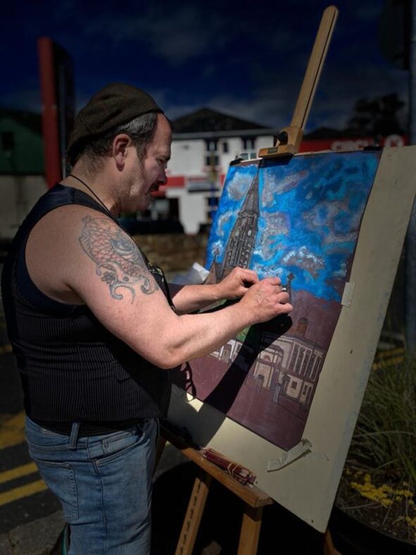 Artist Damien Manning painting St. Joseph's Church and Clifden Courthouse | Thomas O'Sullivan