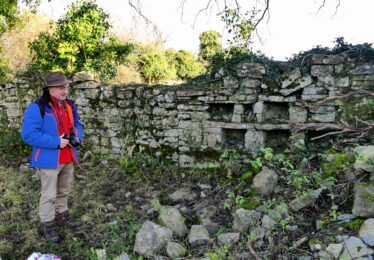 Christy Cunniffe examining a dovecote at Ballinduff Castle | Claire Loader
