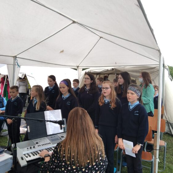 School children provide the singing and music
